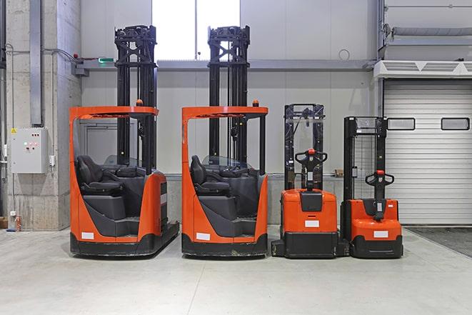 workers operating forklifts in a factory